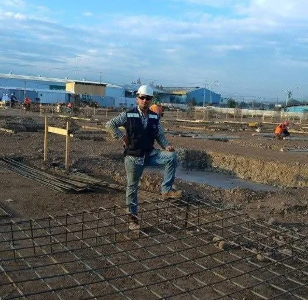 Obrero con bota de seguridad sobre un pilar de hormigón